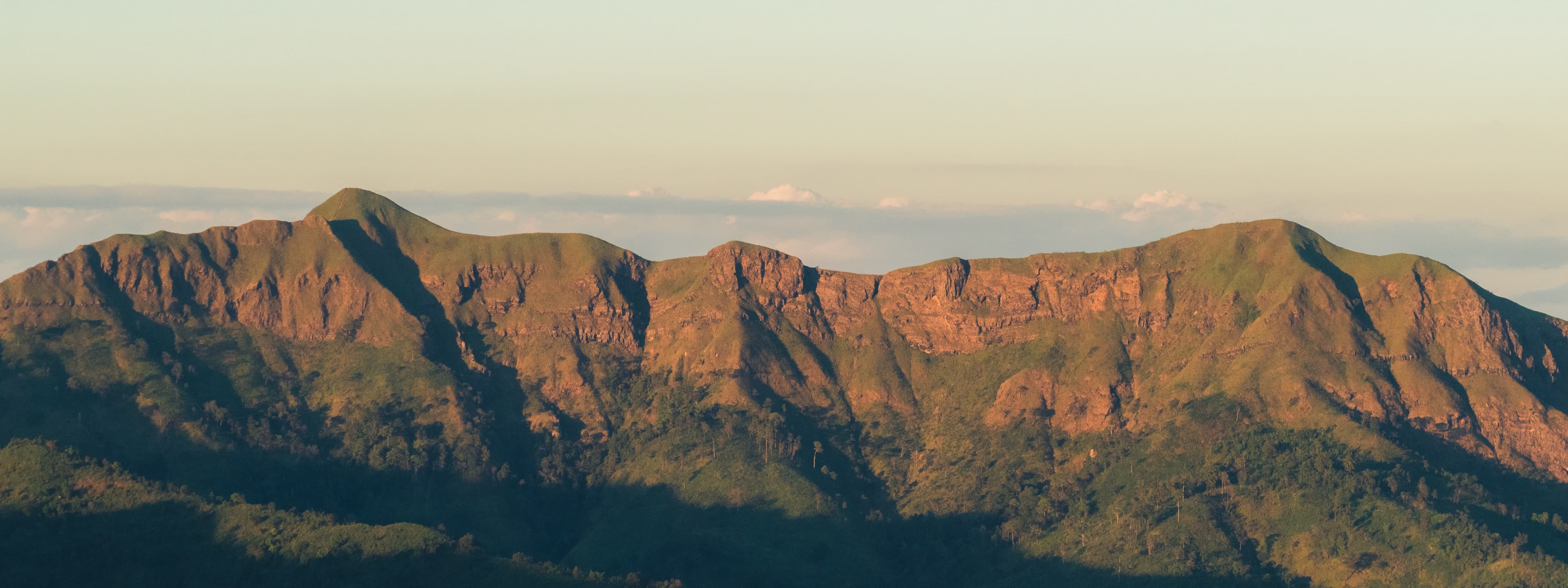 Distant mountain ranges stretch across the horizon, available at Thong Pha Phum.