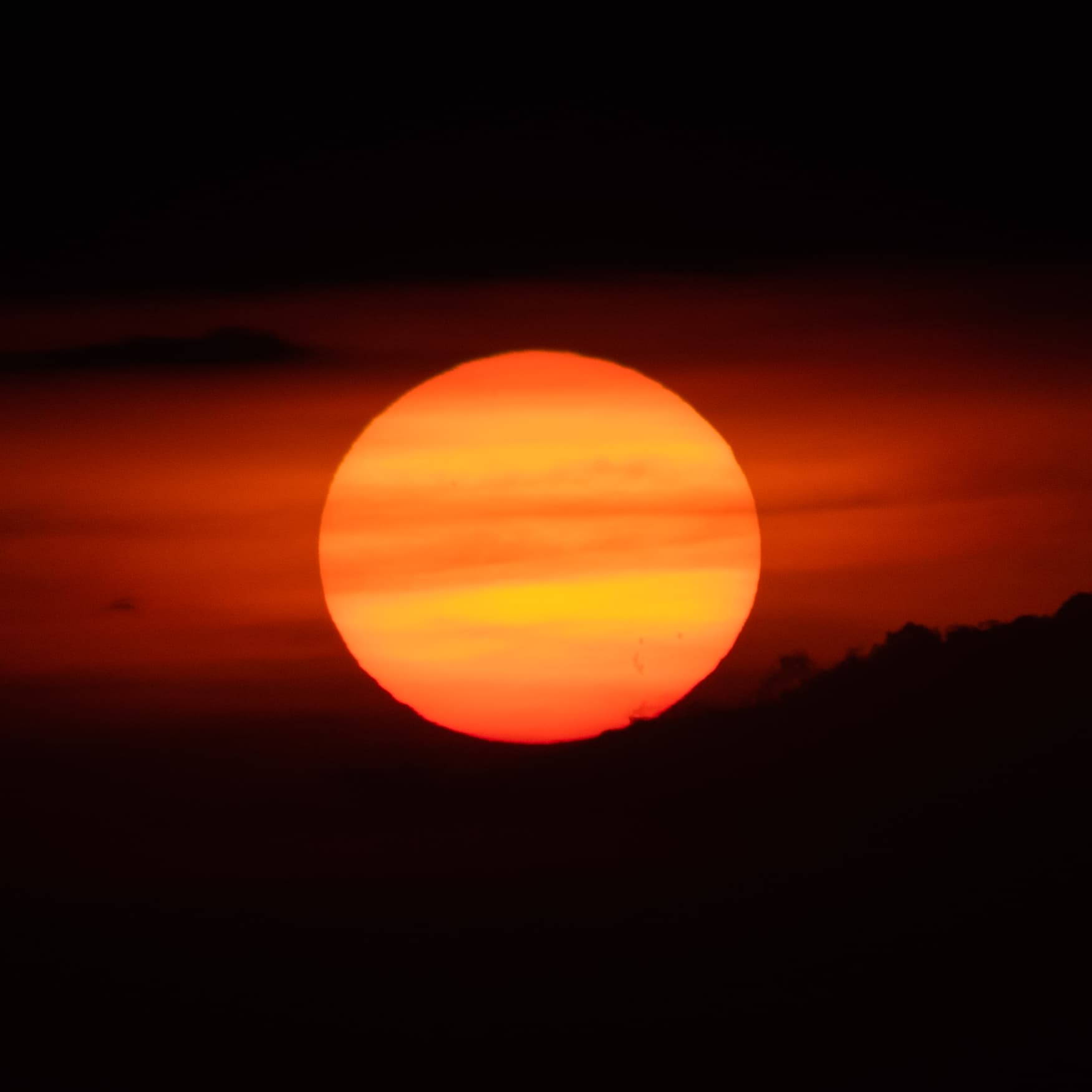 Sunlight breaks through heavy clouds near sunset.