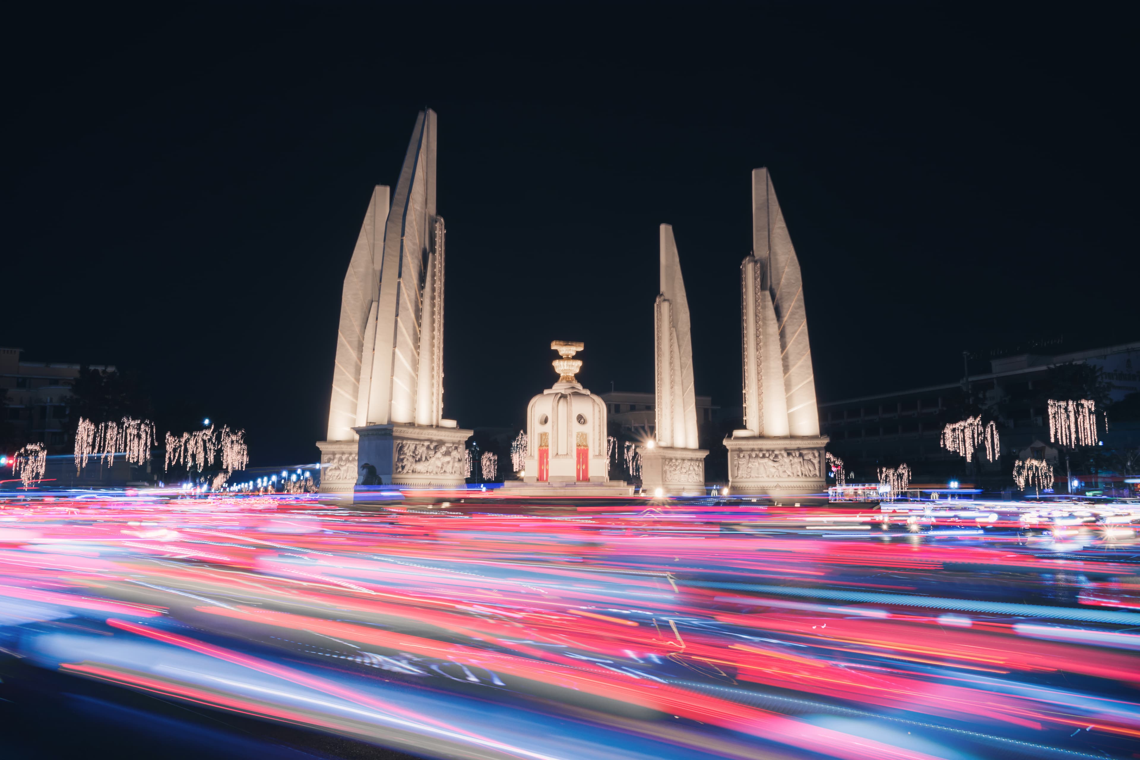 Monument of the Thai democracy with colorful traffic light trails at night